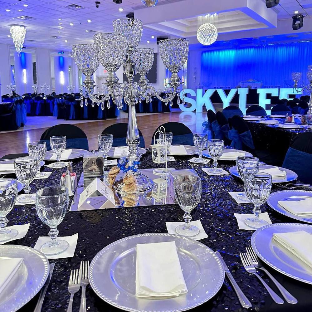 A banquet place setting with glassware and white linen